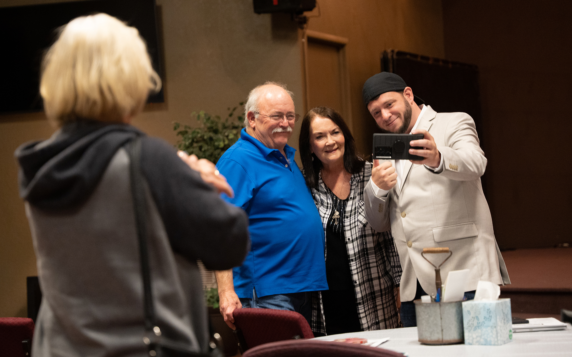 Mike and Kathy Forck take a selfie with Mark Lee Dickson, right, after a Sanctuary Cities for the Unborn interest meeting at Vineyard Church of Prescott Valley. (Photo by Mingson Lau/News21)