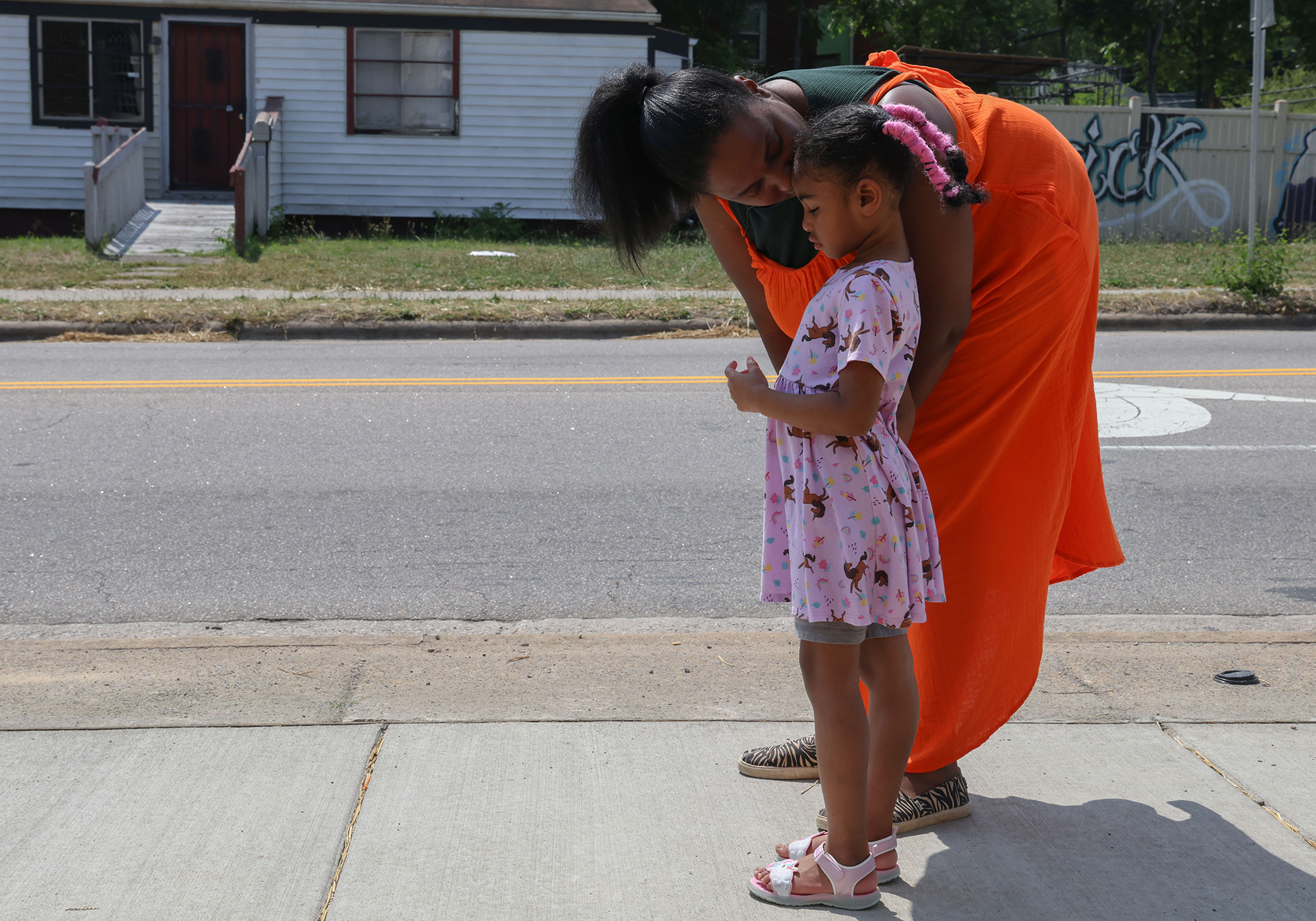 Maya Jackson, founder and executive director of MAAME Inc., walks through a Durham neighborhood with her daughter, Aminah. (Photo by Shelby Rae Wills/News21)