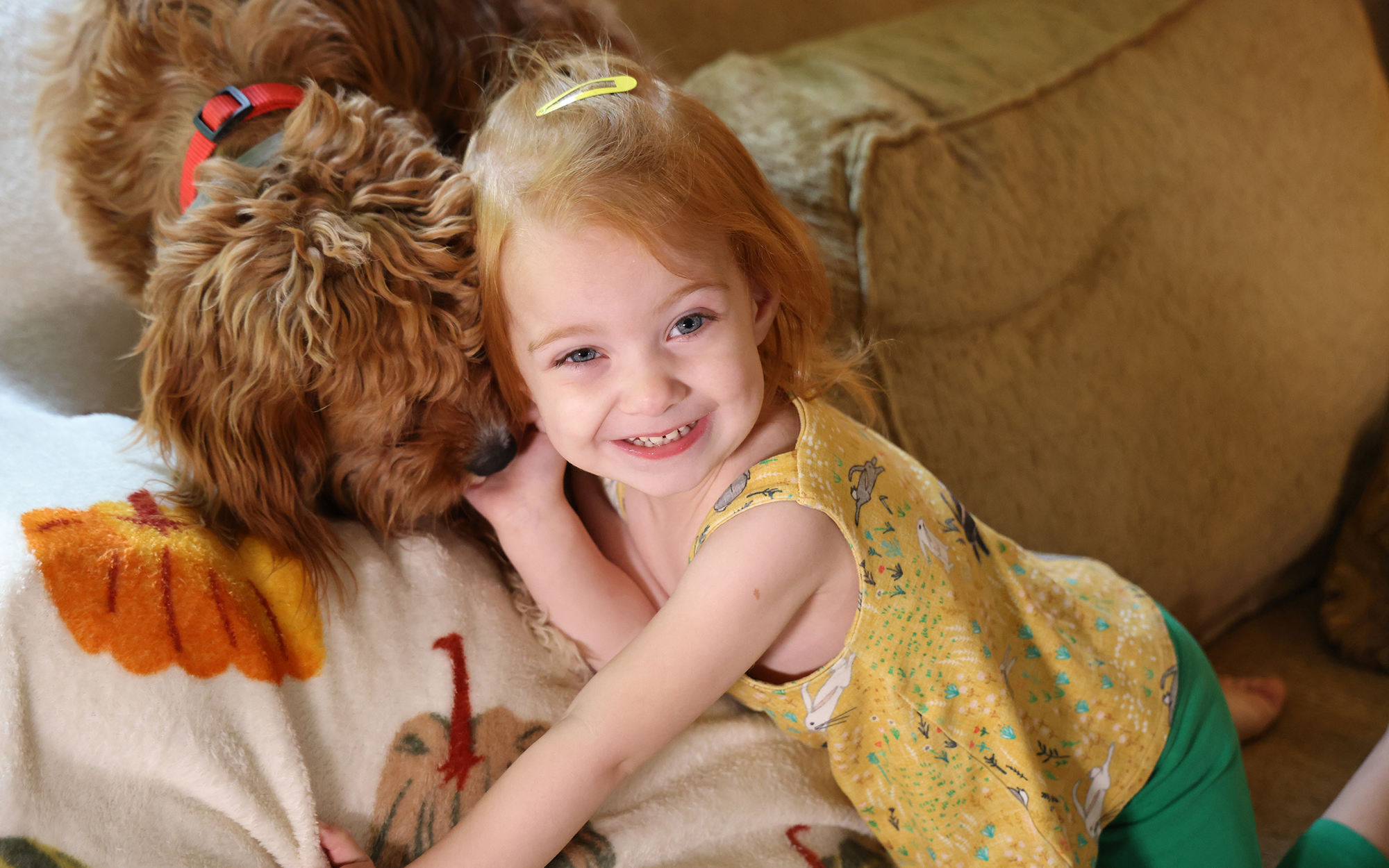 Valerie Norton-Levering plays on the couch with her dog, Tia. (Photo by Morgan Casey/News21)(Photo by Morgan Casey/News21)