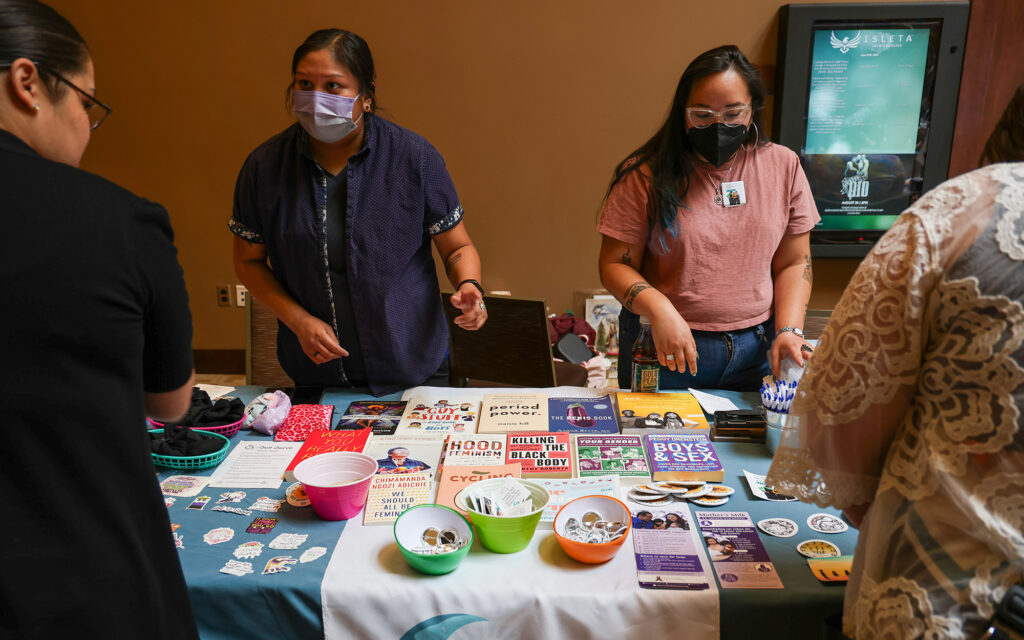Sandy Harris, left, and Jonnette Paddy, right, with Indigenous Women Rising talk about abortion care and reproductive health with attendees at the “Women Are Sacred” conference on June 27, 2023 in Albuquerque, N.M. (Photo by Noel Lyn Smith/News21)