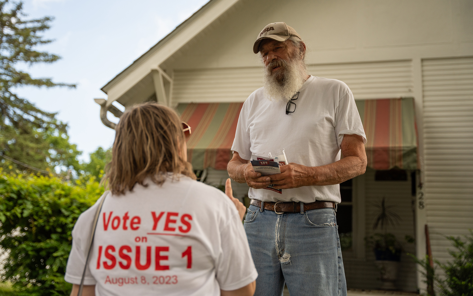 Janine Baker, president of the Delaware City Republican Club, left, urges Larry Kenney to vote “yes” on Ohio State Issue 1 while canvassing on June 24, 2023, in Delaware, Ohio. An Aug. 8 special election aims to increase the threshold required to change the state constitution. (Photo by Mingson Lau/News21)