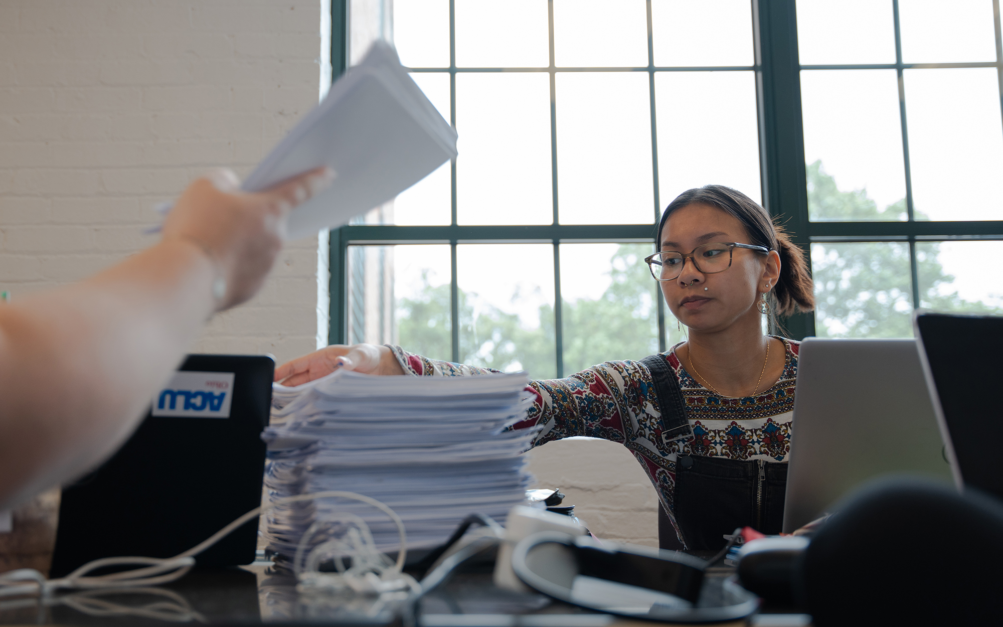 Asia Ven sorts petitions on June 26, 2023, at the American Civil Liberties Union of Ohio office in Columbus. (Photo by Mingson Lau/News21)