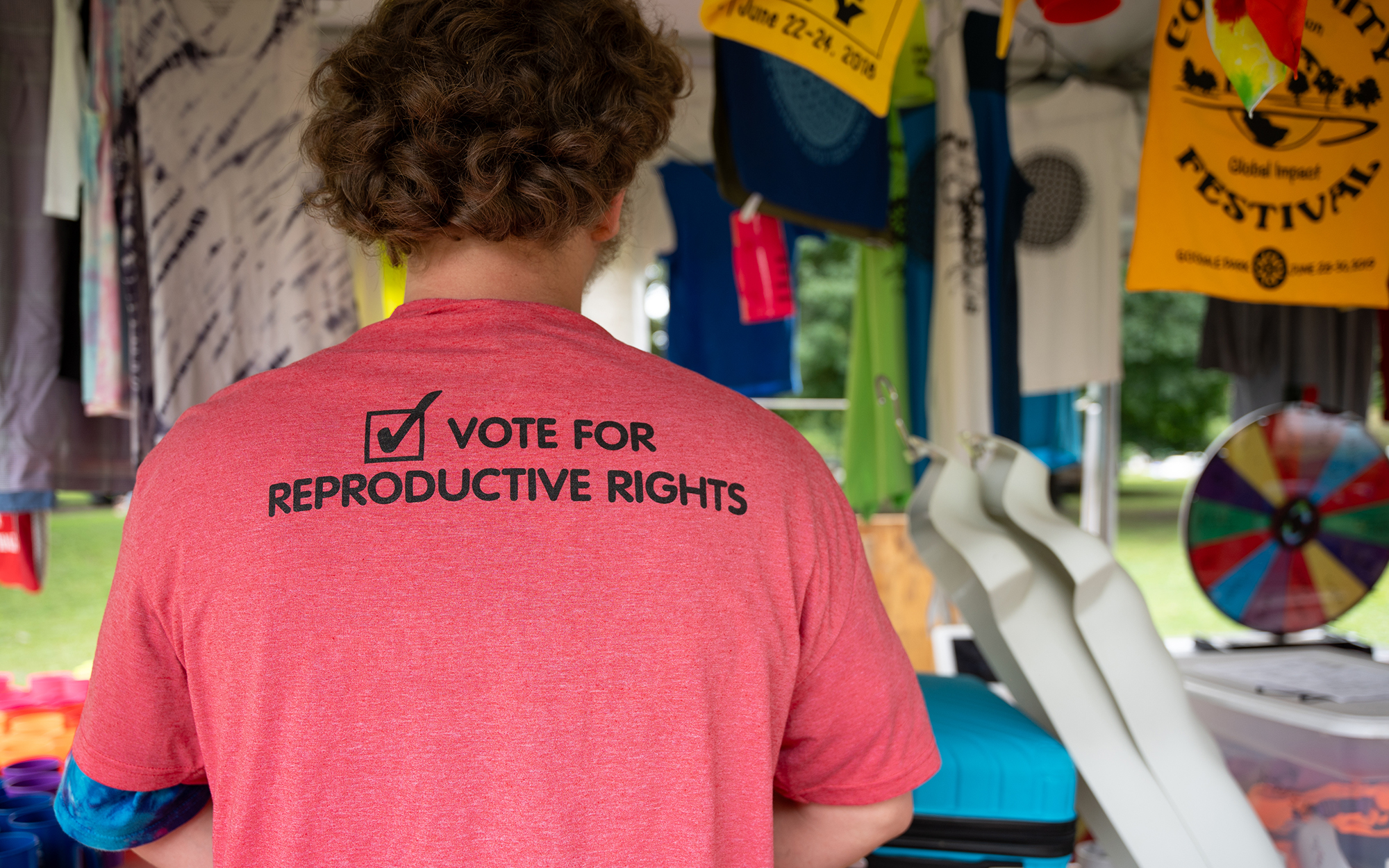 Donovan Fletcher sports an abortion-rights T-shirt as he works a booth at a community festival in Columbus, Ohio, on June 23, 2023. (Photo by Mingson Lau/News21)